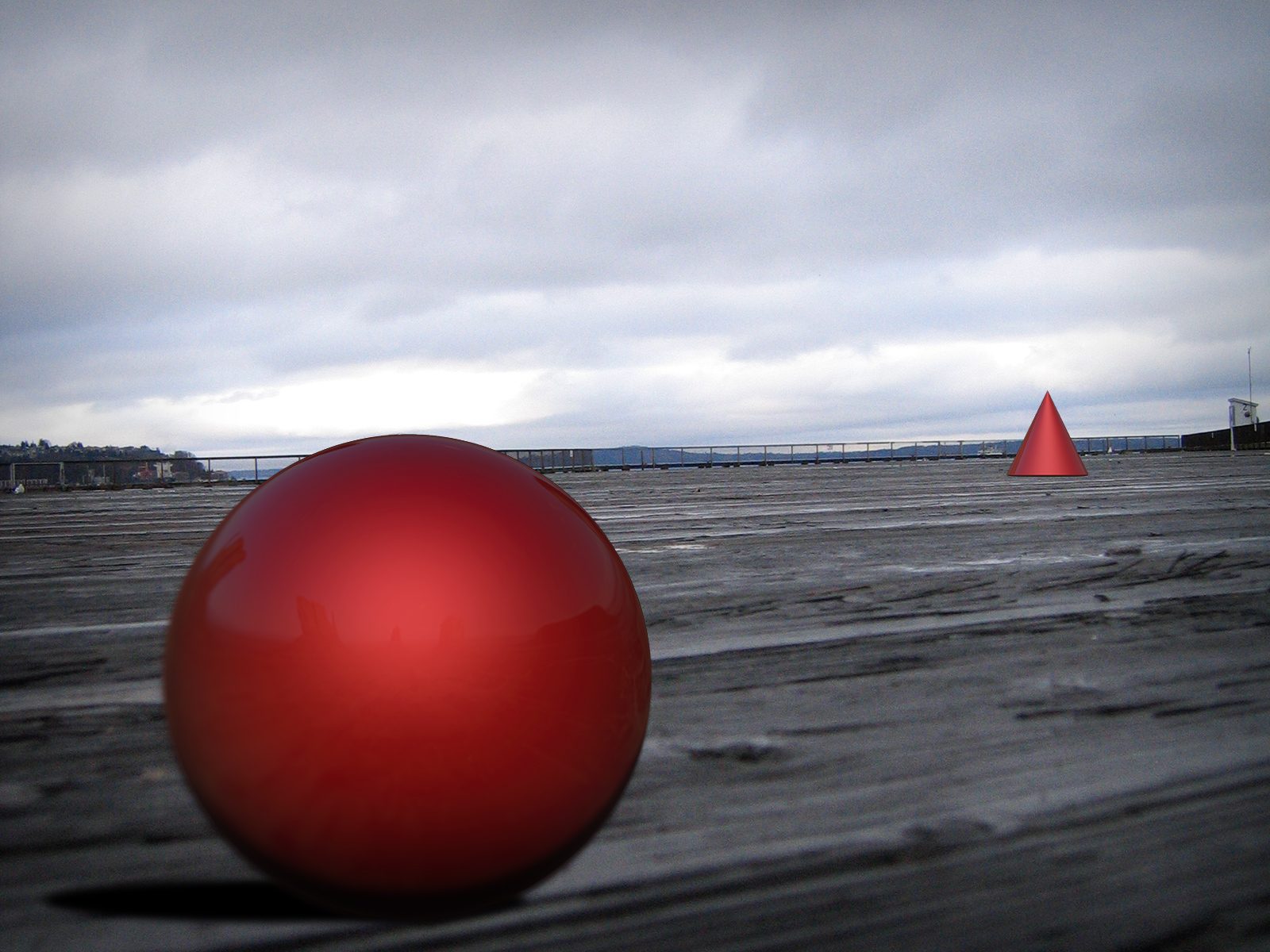 A shaded red sphere and cone placed on a wooden pier under a cloudy sky, where size, overlap and perspective create a sense of depth and space.